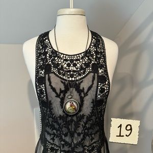 Long bird locket style necklace.